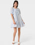Woman wearing a light blue dress on a white background