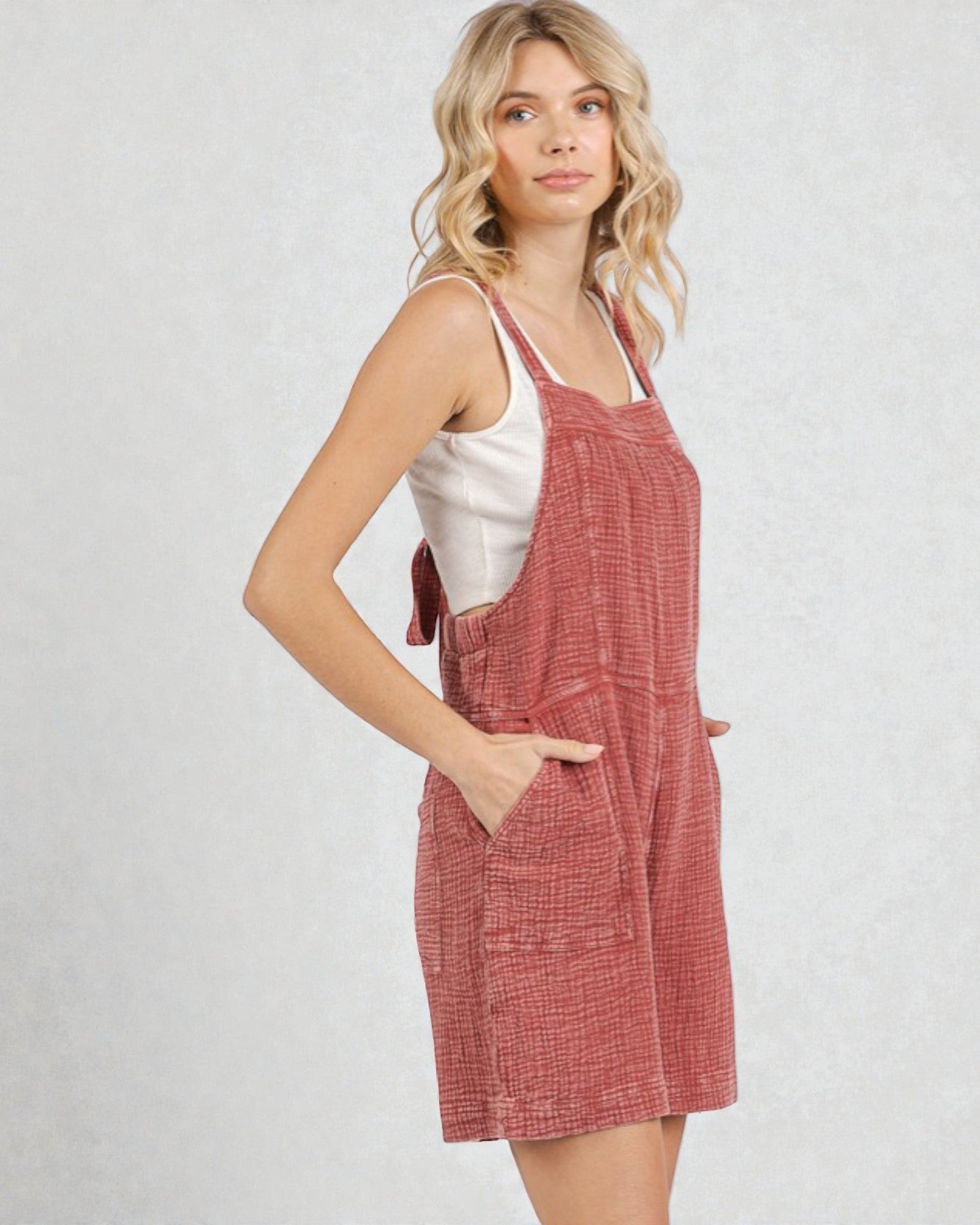 Woman wearing a red checkered dress against a white background