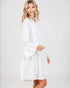 Woman wearing a white dress against a plain background