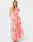 Woman wearing a red and white floral dress on a white background