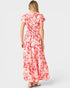 Woman wearing a red and white floral dress on a white background
