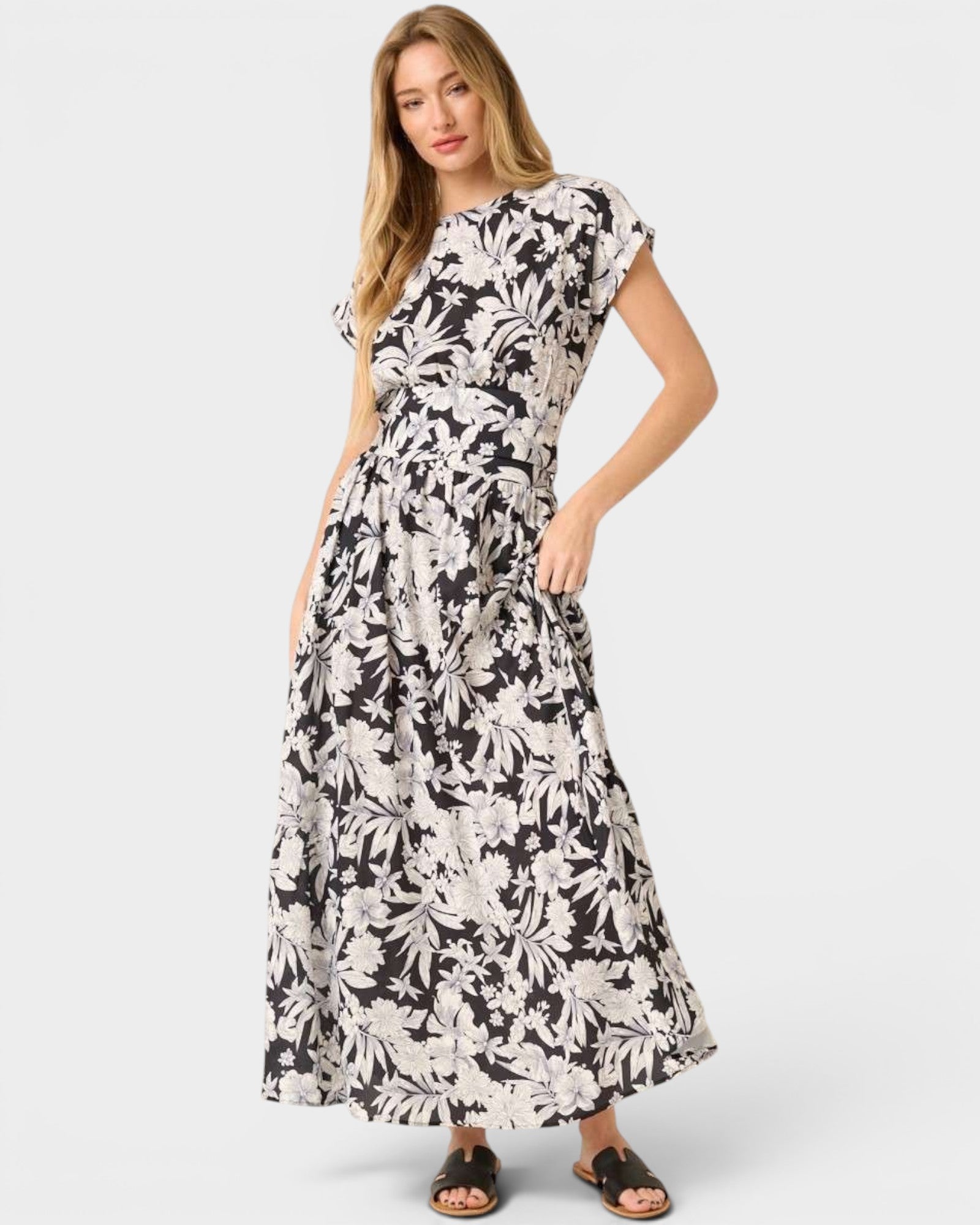 Woman wearing a black and white floral dress on a white background