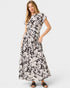 Woman wearing a black and white floral dress on a white background