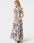 Woman wearing a black and white floral dress on a white background