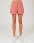 Person wearing pink plaid shorts on a white background