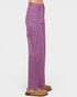 Purple pants worn by a person on a white background