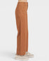 Brown pants worn by a person on a white background