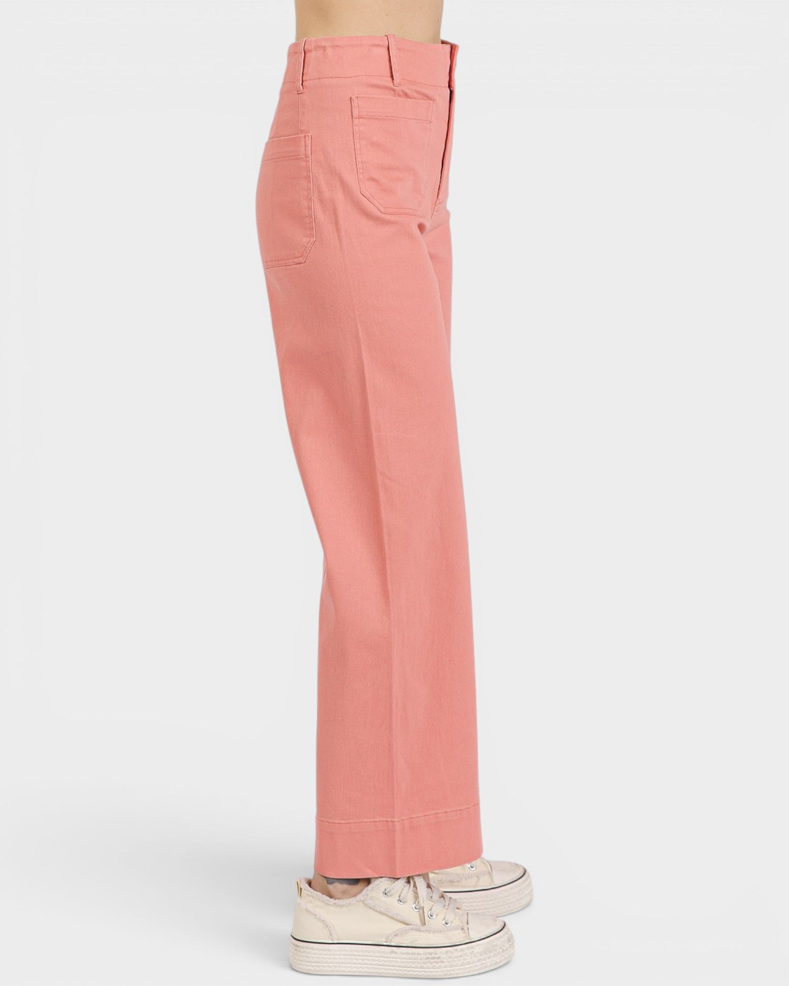 Coral pants worn by a person on a white background