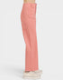 Coral pants worn by a person on a white background