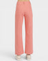 Coral pants worn by a person on a white background
