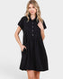 Woman wearing a black dress with short sleeves on a white background