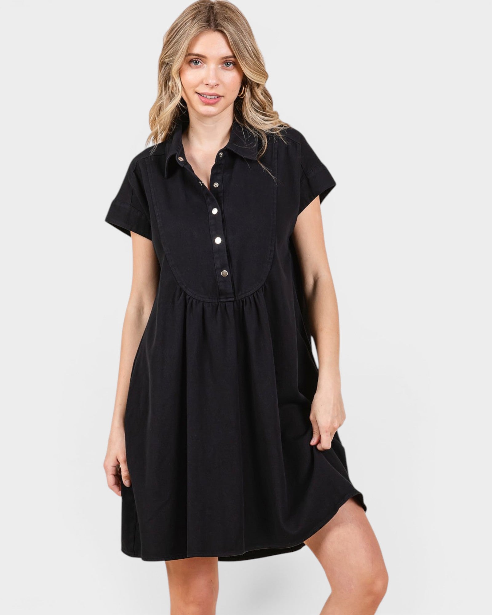 Woman wearing a black dress with a white background