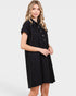 Woman wearing a black dress with buttons on a white background