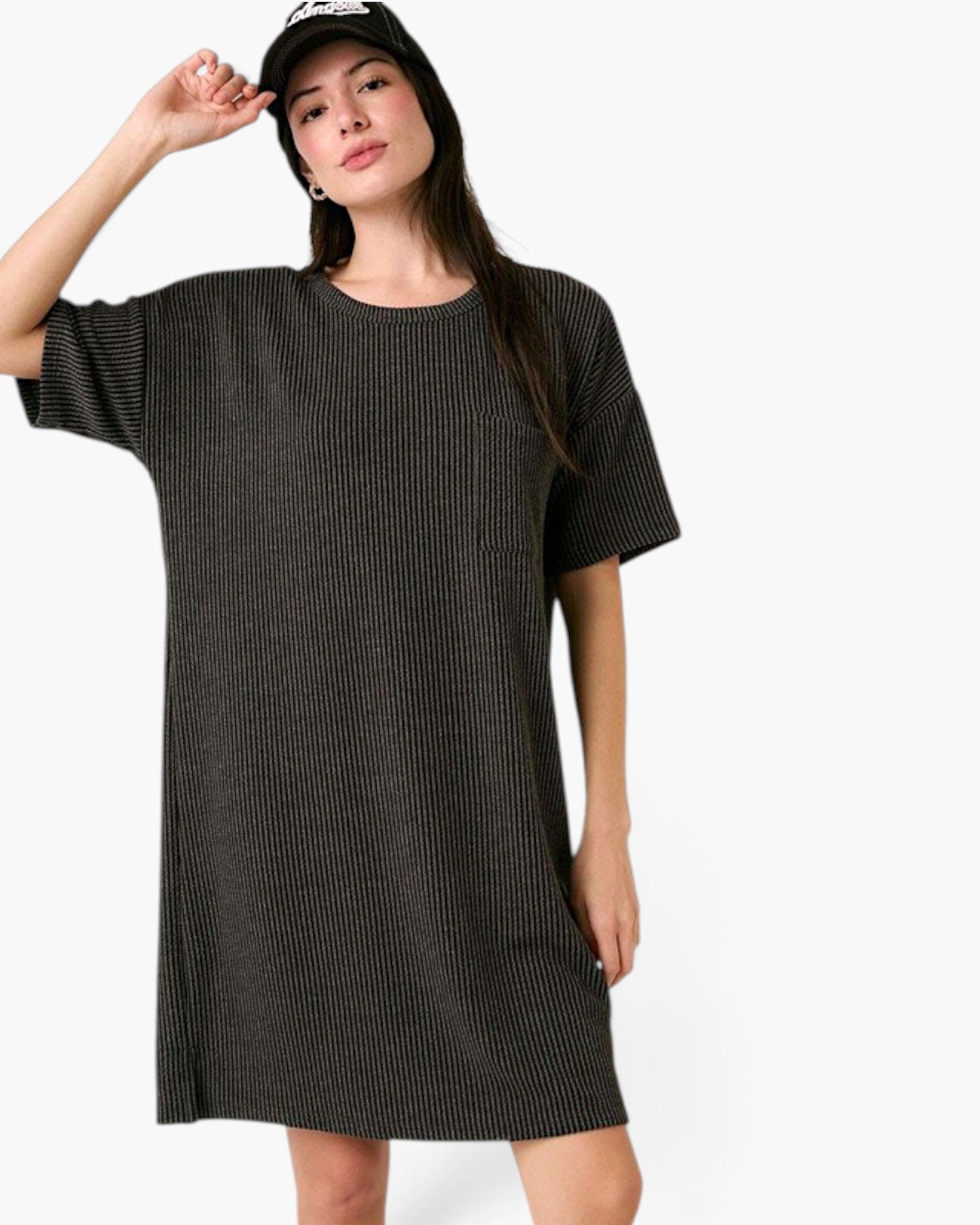 A woman wearing a dark charcoal gray ribbed short-sleeve t-shirt dress and a black baseball cap, posing against a solid white background.
