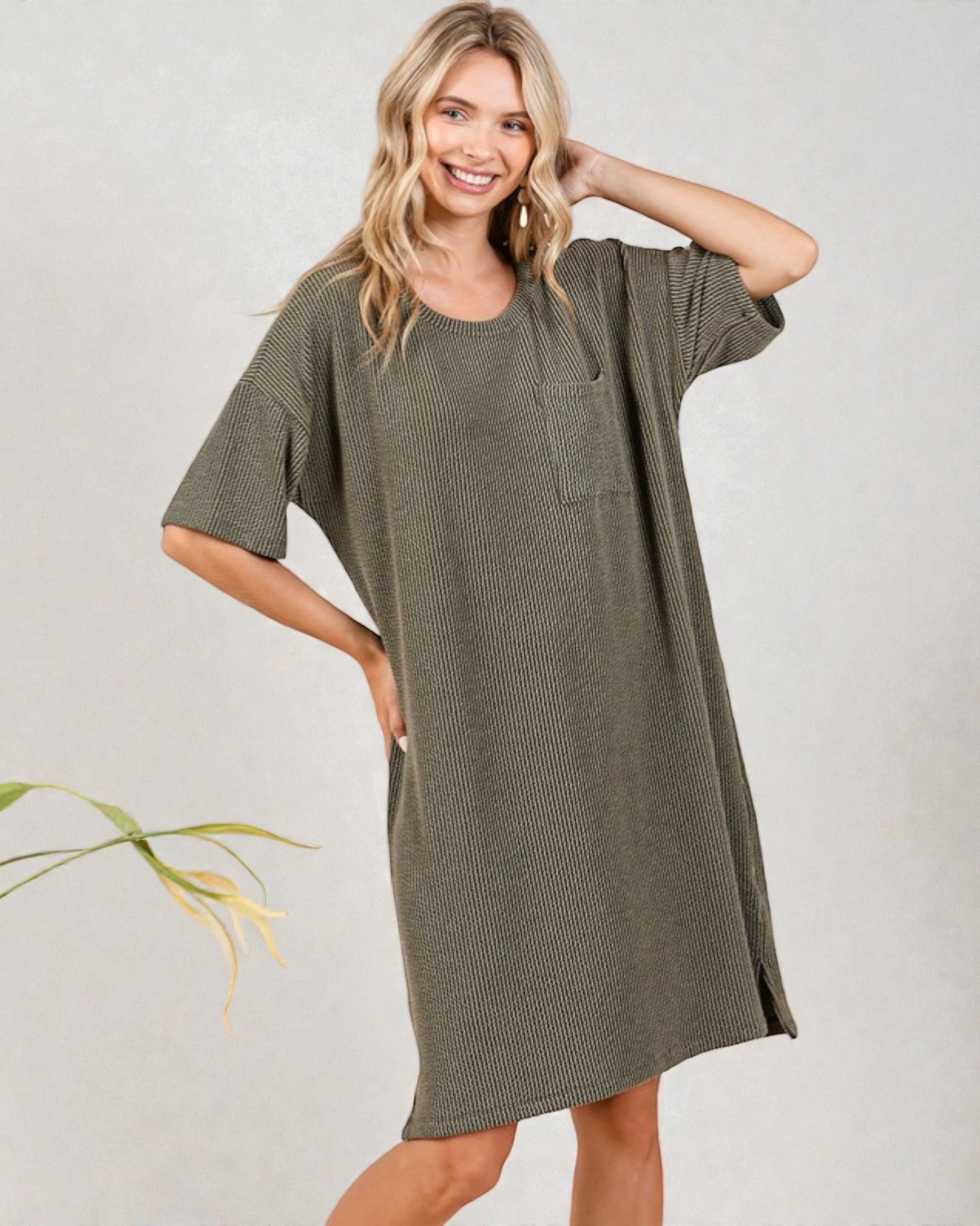 Woman wearing a green dress with a plain background