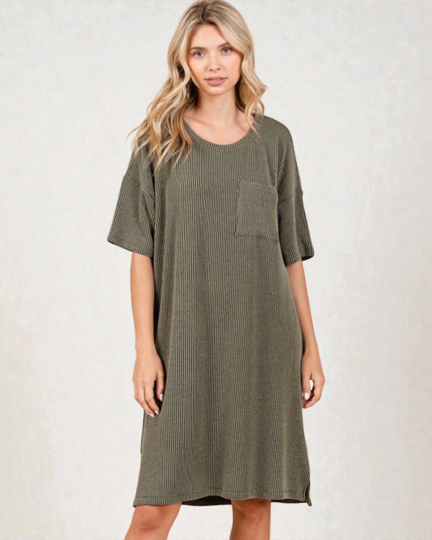 Woman wearing a green dress with a pocket on a white background