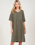 Woman wearing a green dress with a pocket on a white background