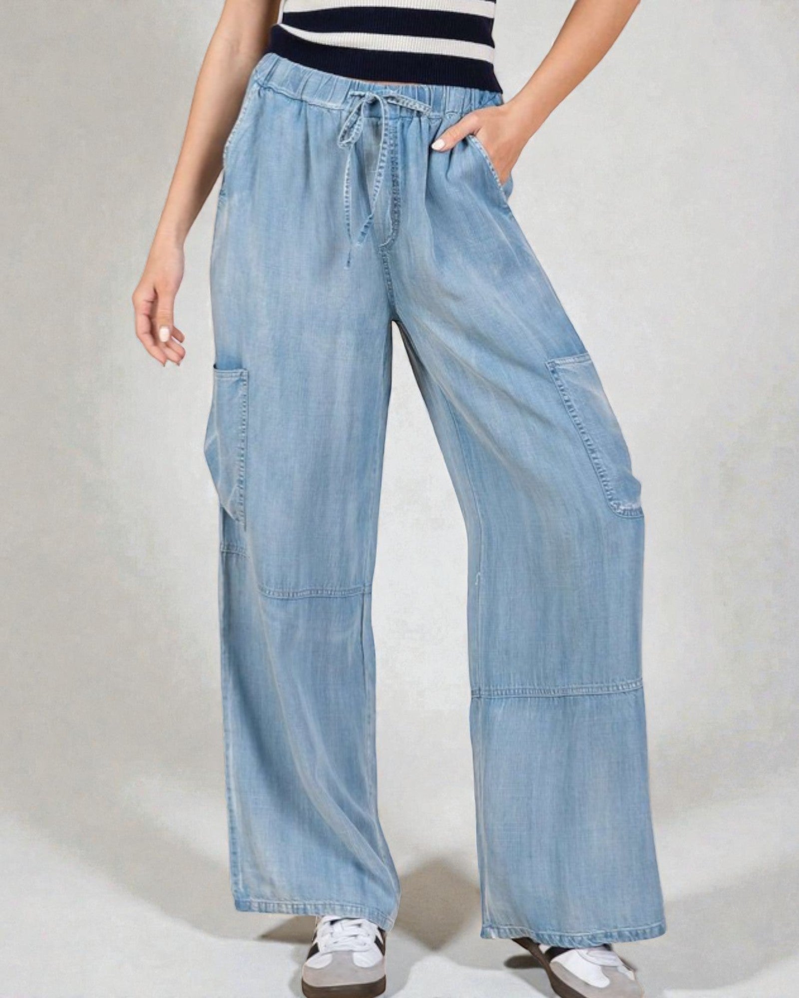 Light blue denim wide-leg pants worn by a person on a plain background