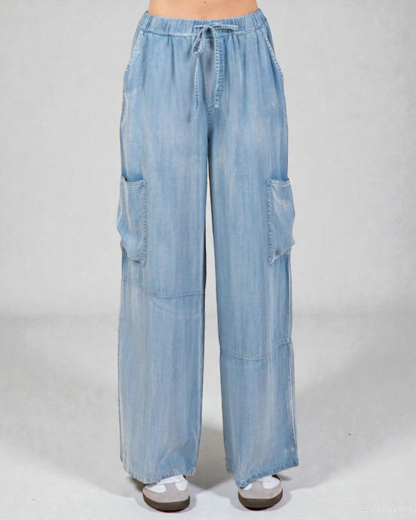 Light blue denim cargo pants on a white background