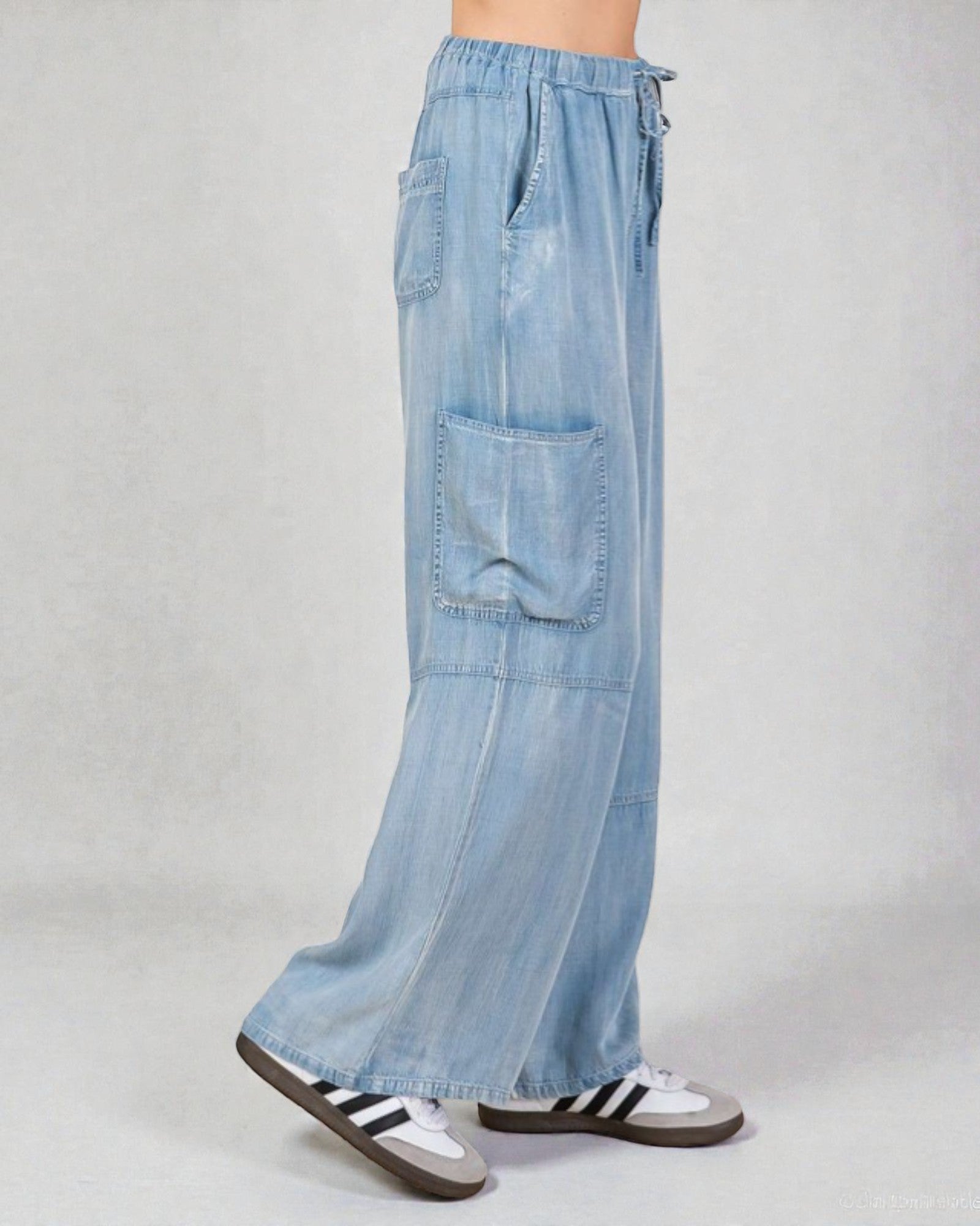 Light blue denim cargo pants on a plain background