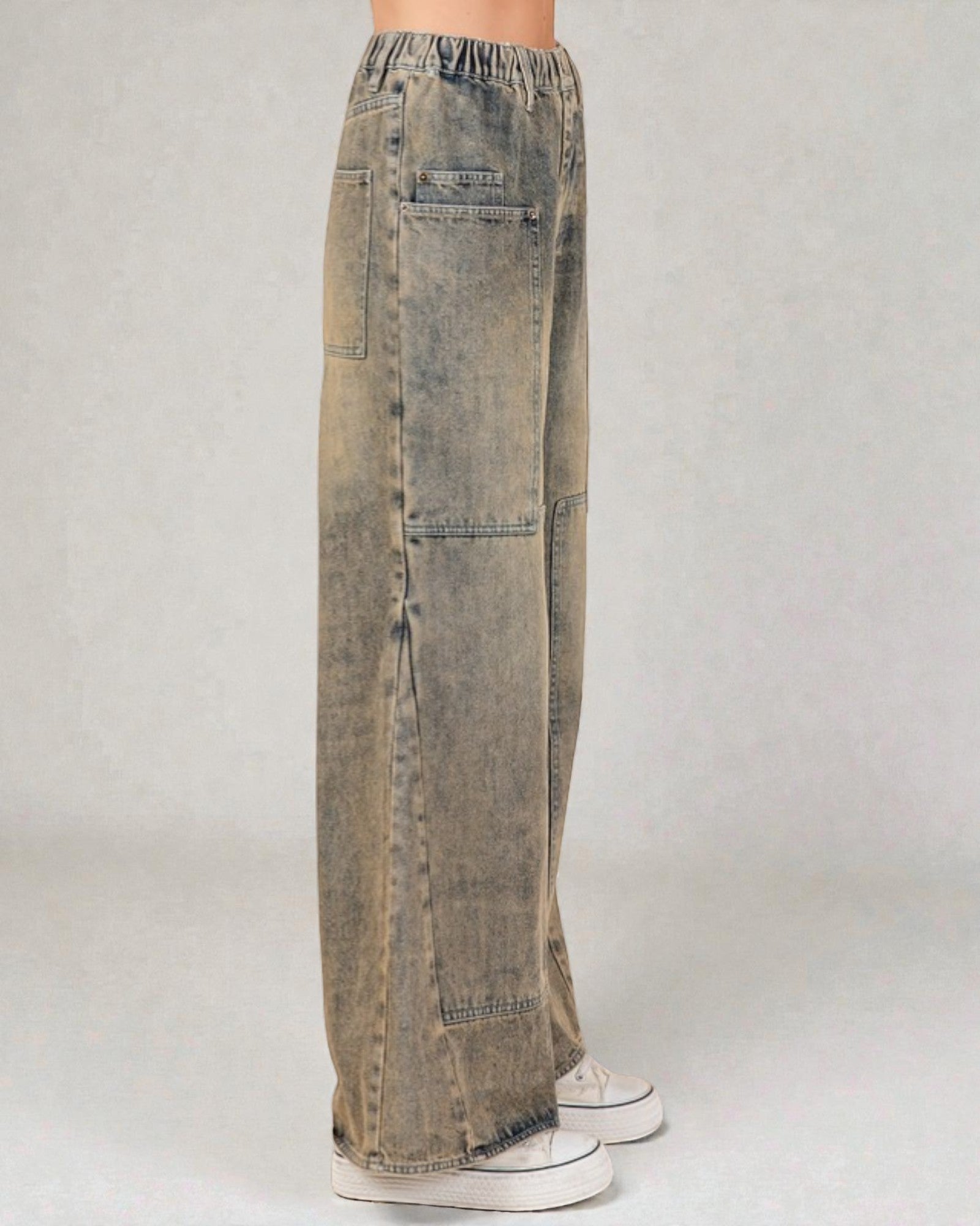 Distressed jeans worn by a person on a plain background