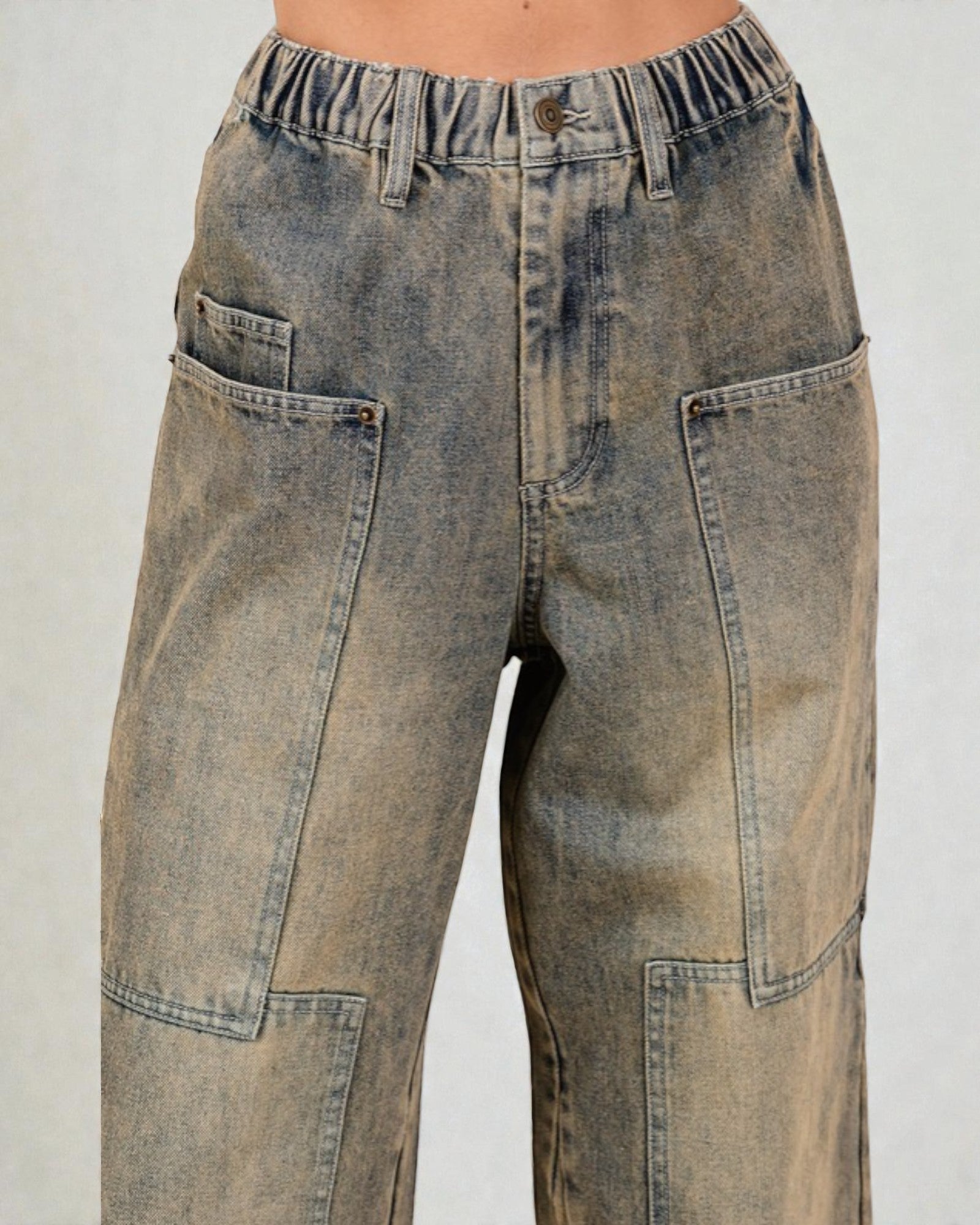 Pair of distressed jeans on a plain background