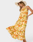 Woman wearing a yellow floral dress on a white background