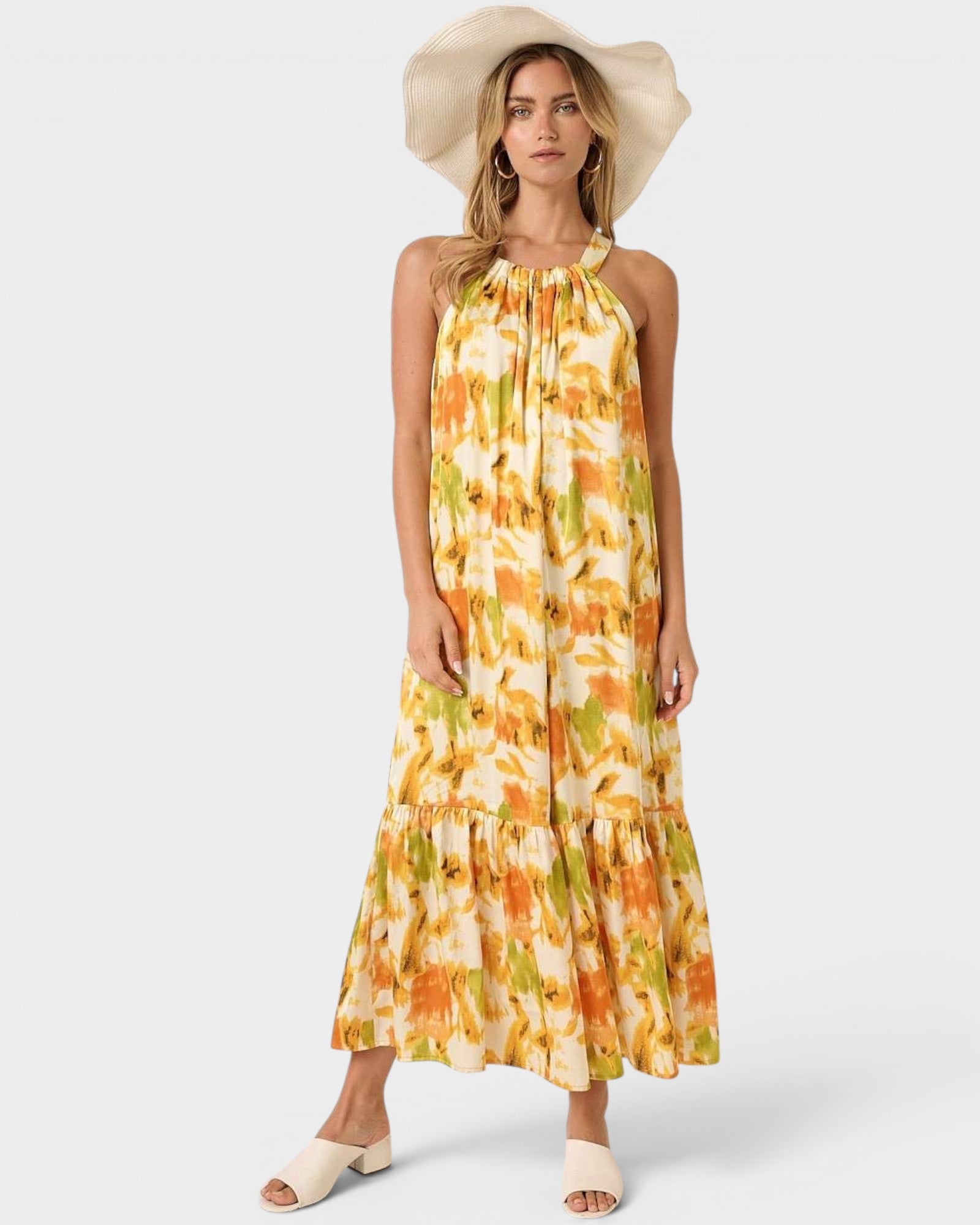 Woman wearing a floral dress and wide-brimmed hat on a white background