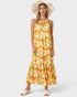 Woman wearing a floral dress and wide-brimmed hat on a white background