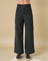 Black cargo pants worn by a person on a beige background