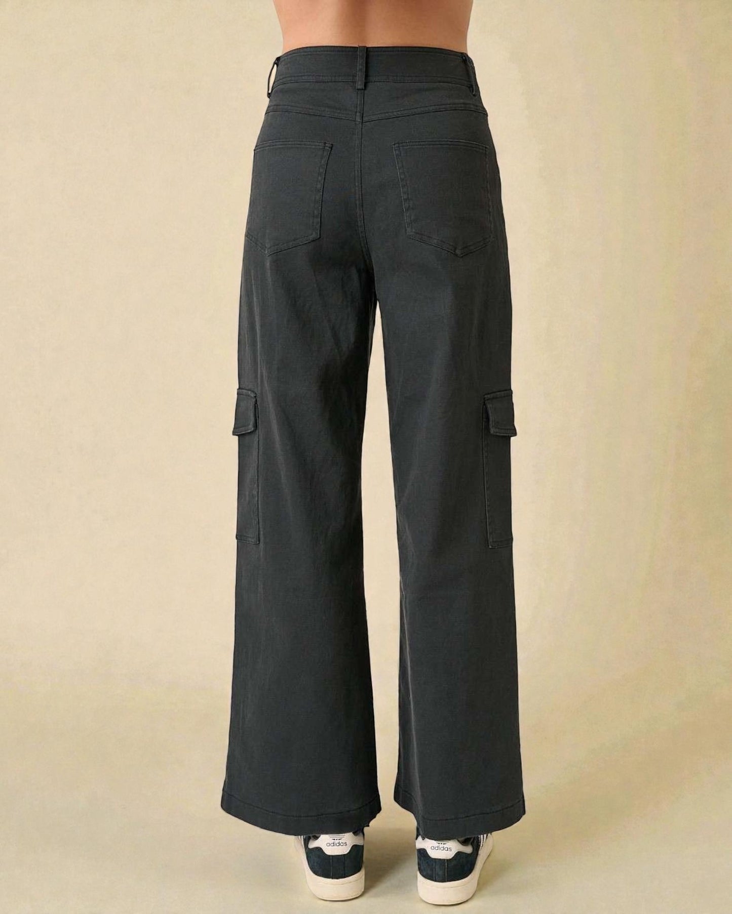 Black cargo pants on a beige background