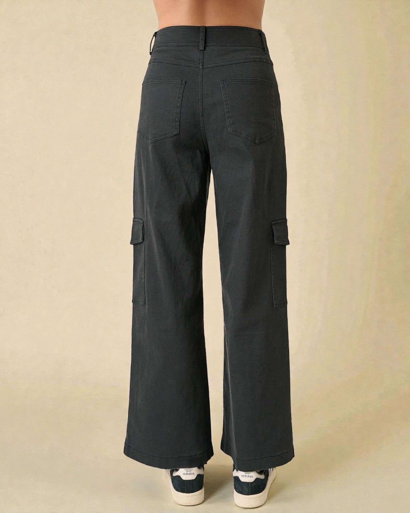 Black cargo pants on a beige background