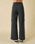 Black cargo pants on a beige background