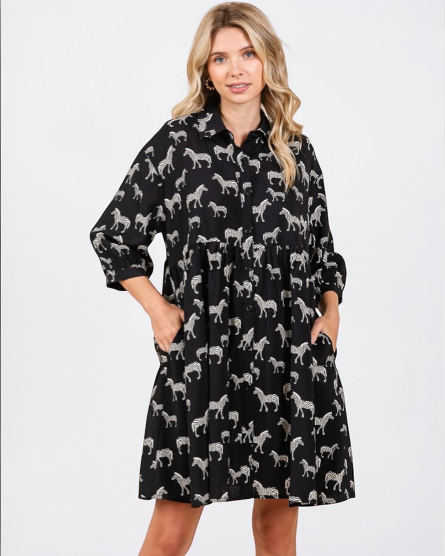 Woman wearing a black dress with zebra pattern on a white background