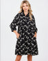 Woman wearing a black dress with zebra pattern on a white background