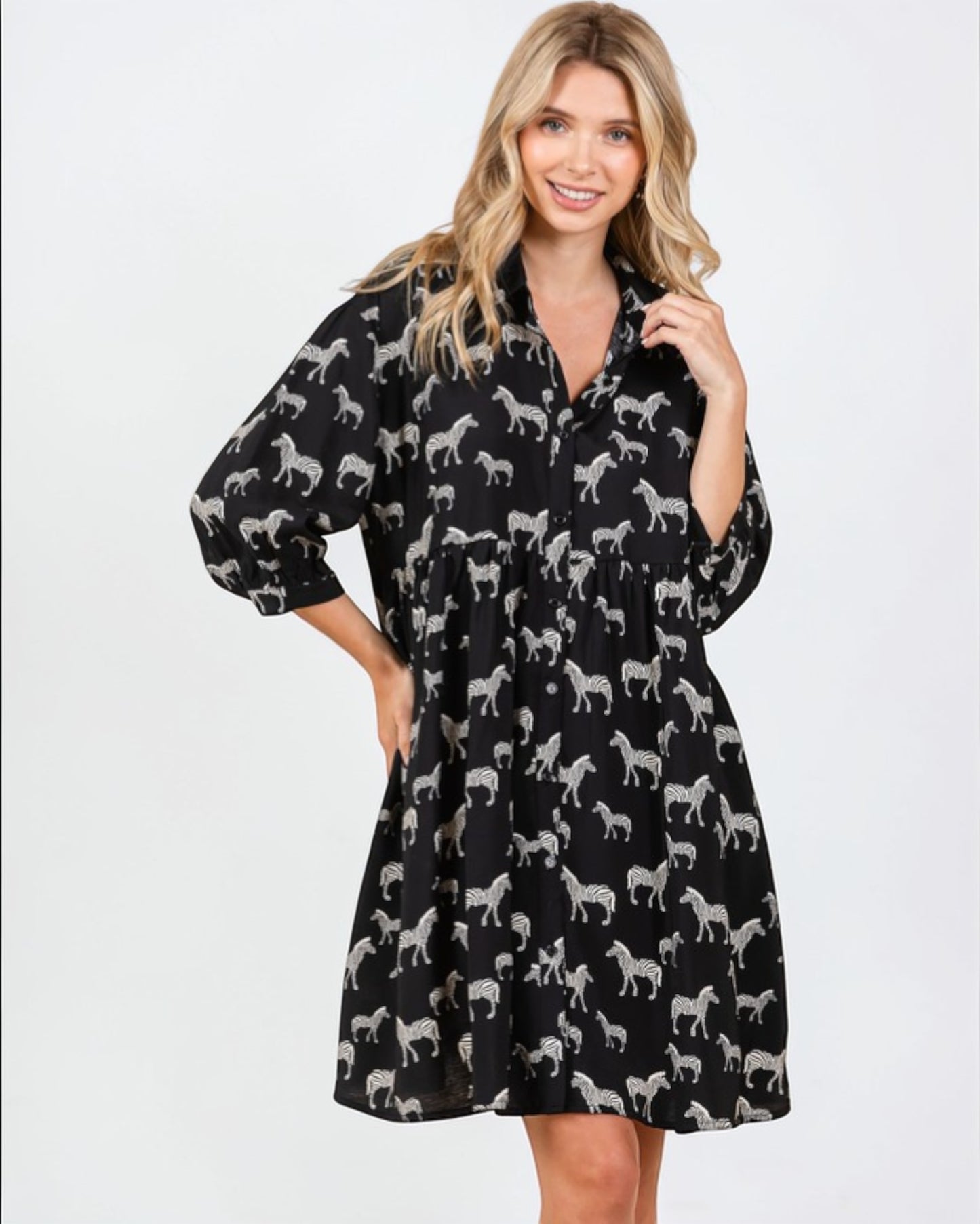 Woman wearing a black dress with white zebra pattern on a white background