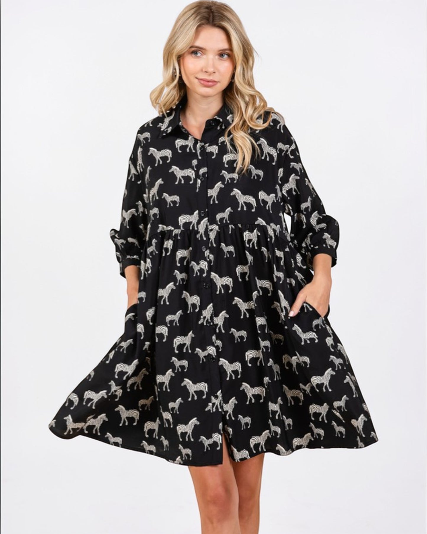 Woman wearing a black dress with zebra pattern on a white background