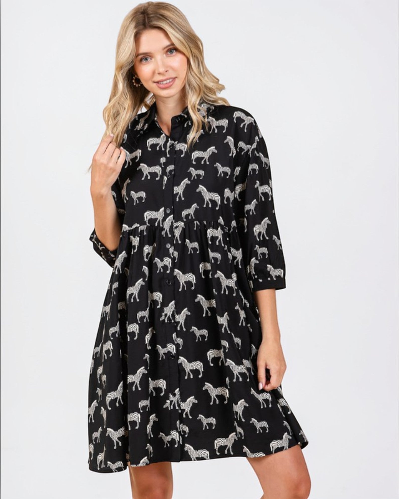 Woman wearing a black dress with white zebra pattern on a white background