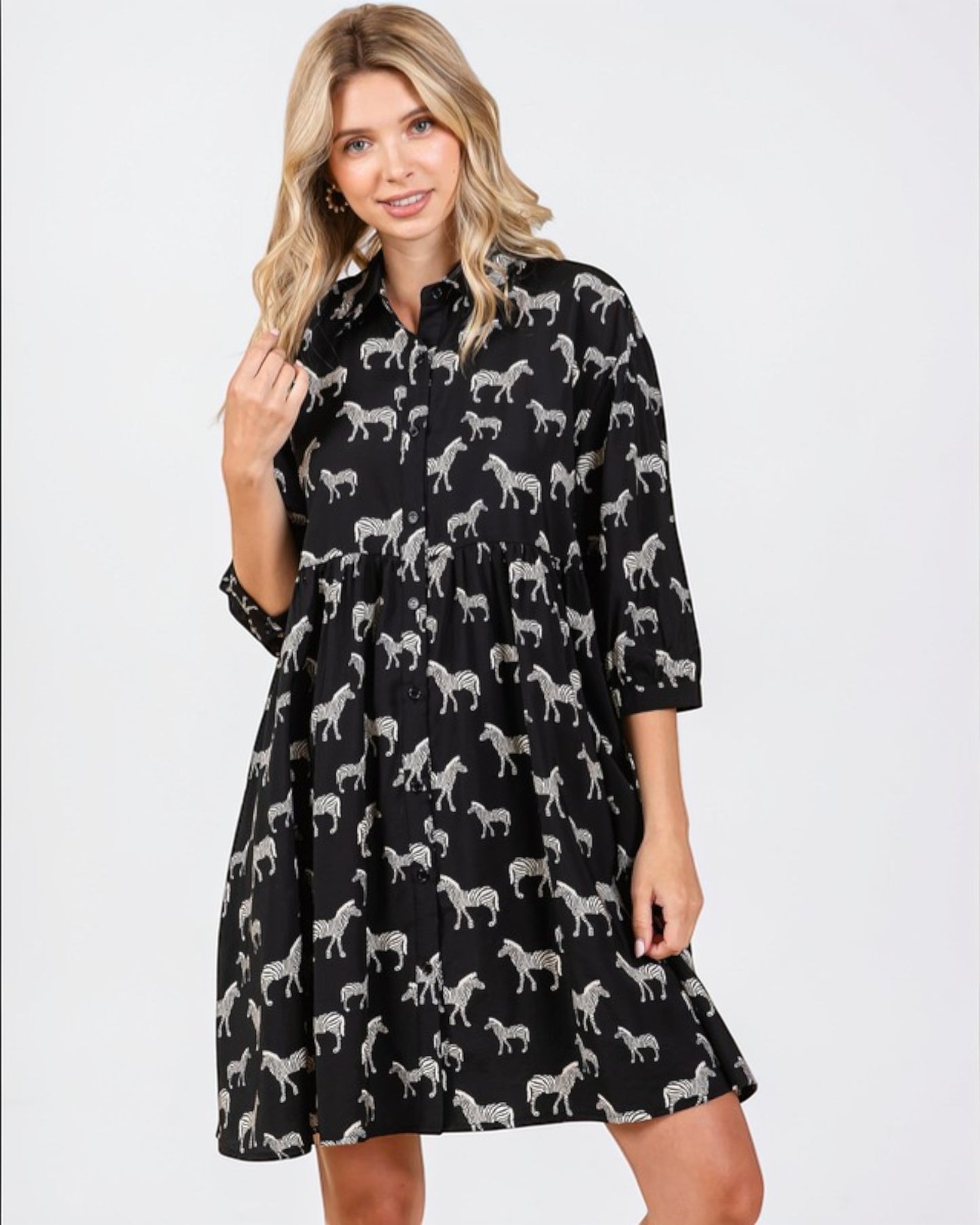 Woman wearing a black dress with white zebra pattern on a white background