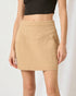 Beige skirt worn by a person on a plain background