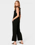 Woman wearing a black sleeveless jumpsuit on a white background