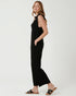 Woman wearing a black sleeveless jumpsuit on a white background