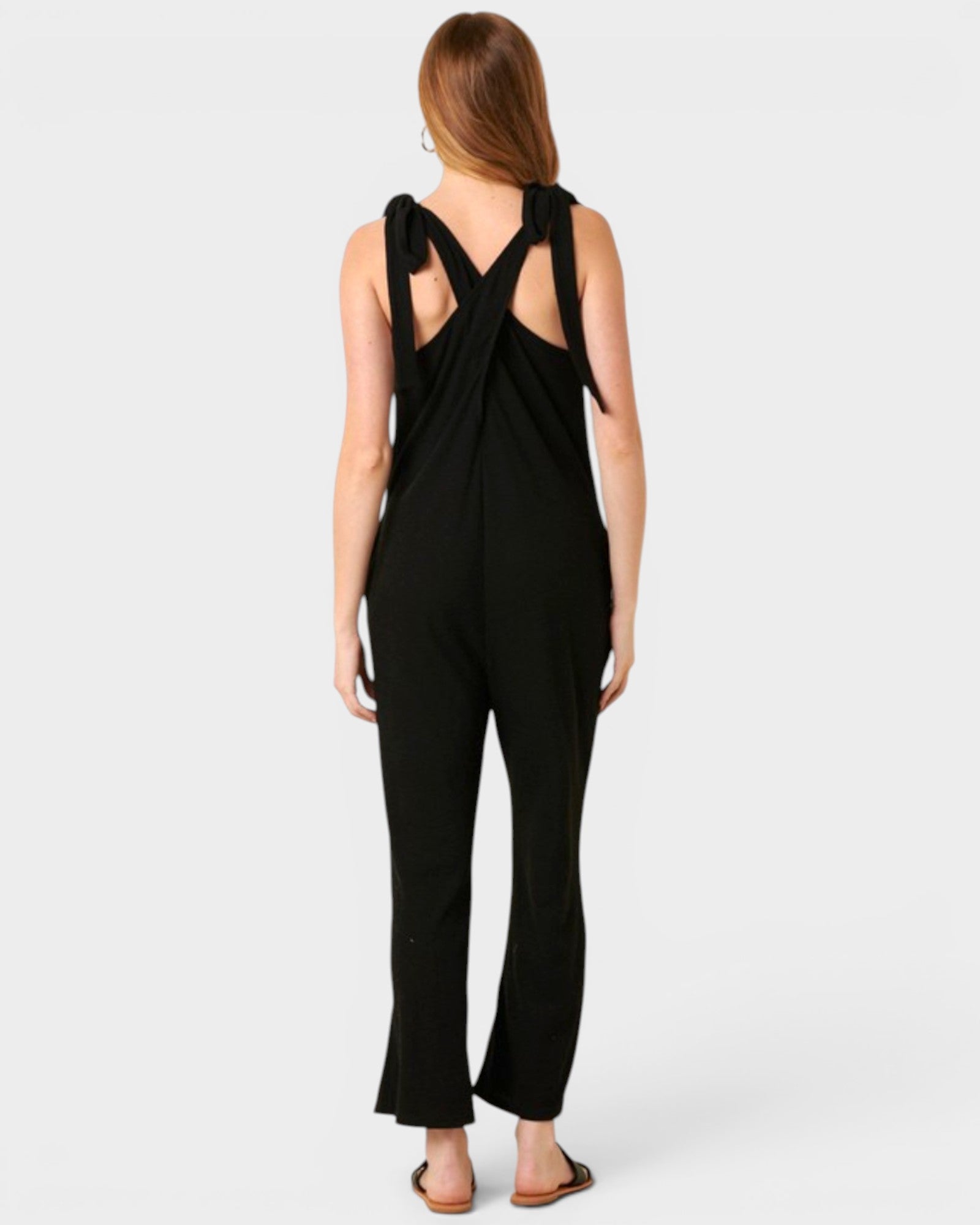 Black jumpsuit with open back on a white background