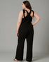 Woman wearing a black jumpsuit with a gray background