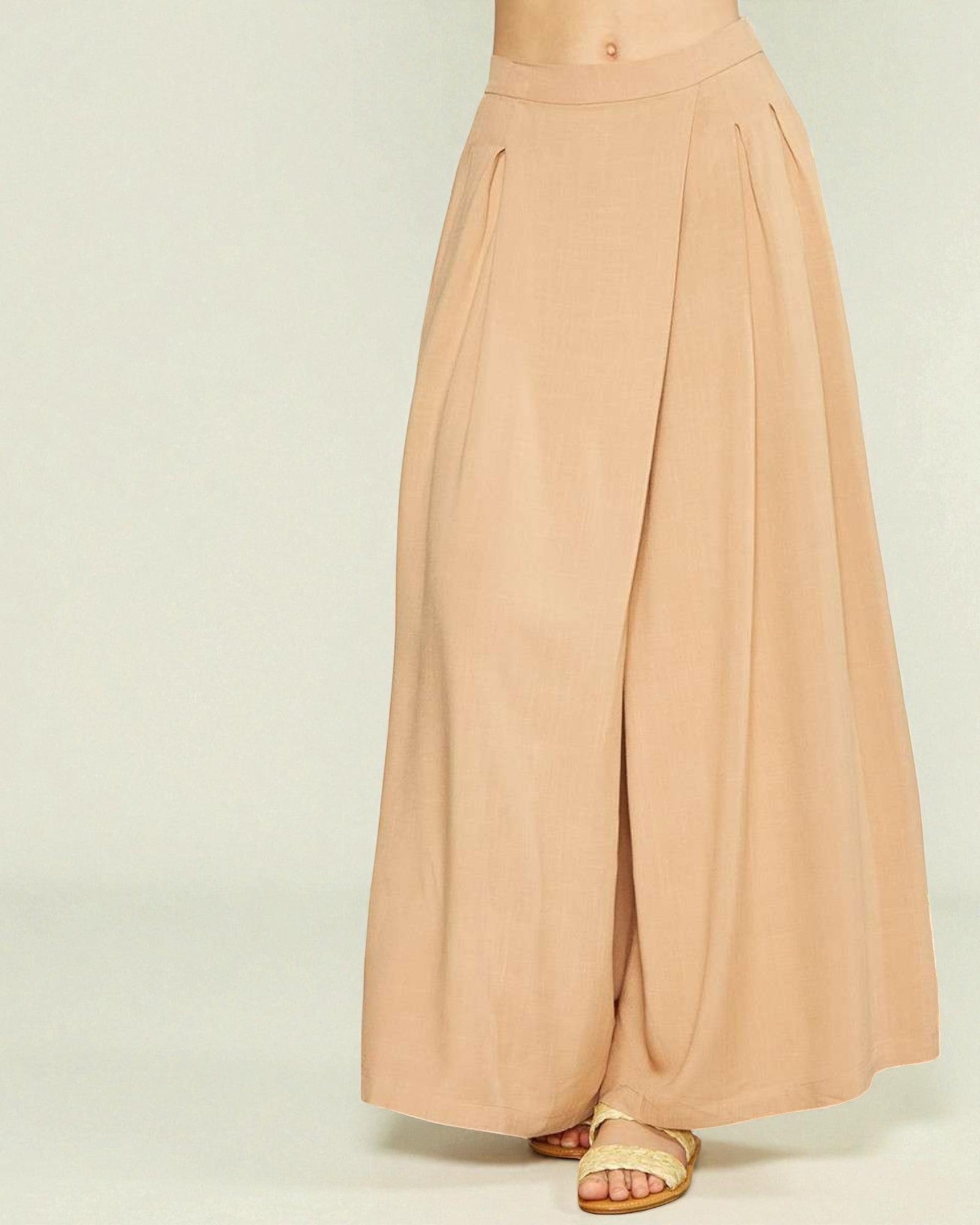 Beige wide-leg pants on a plain background