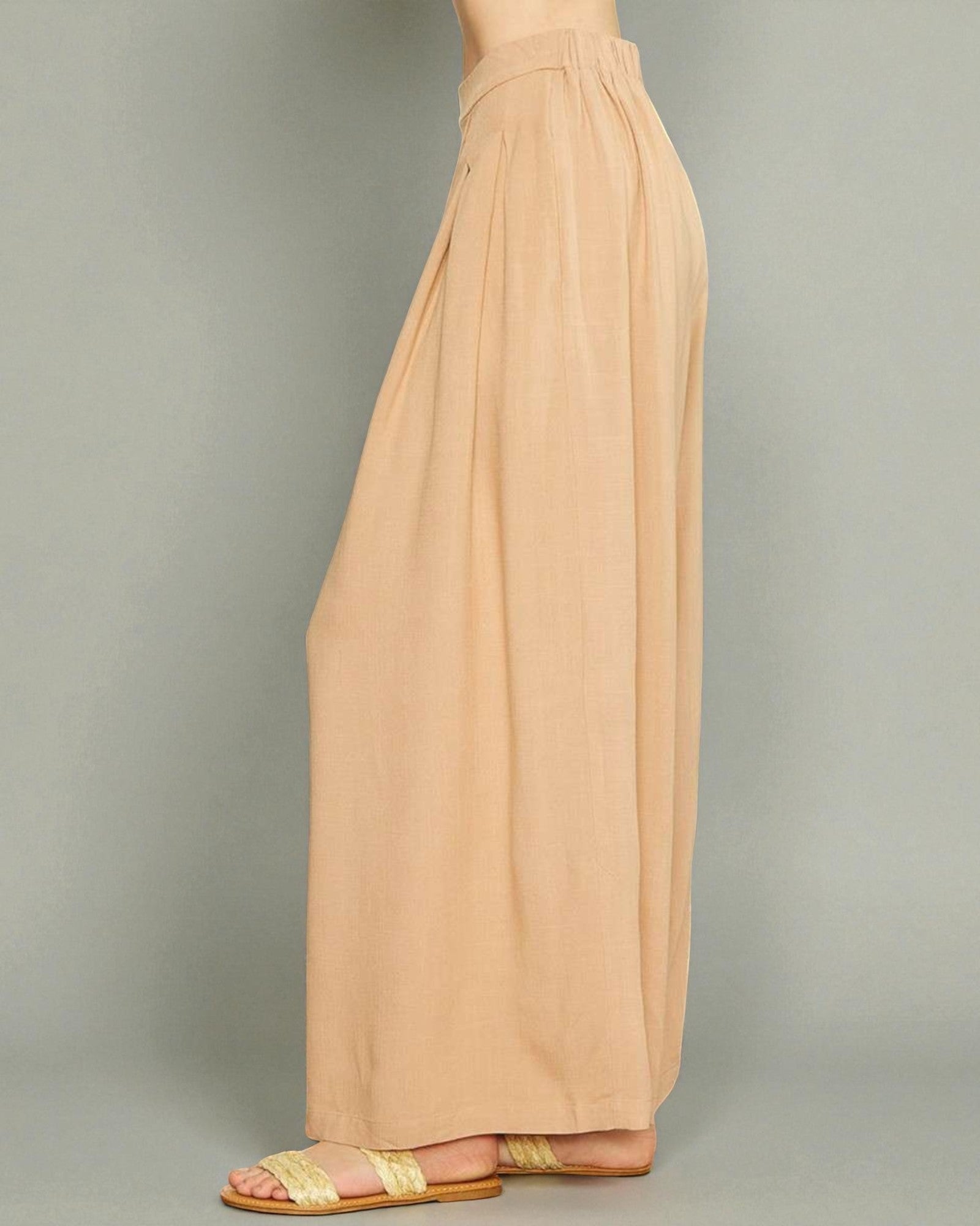 Beige wide-leg pants on a neutral background