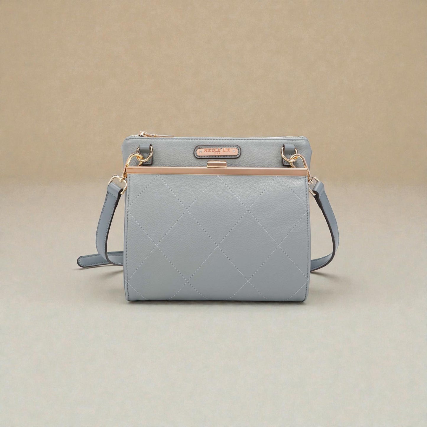 Light blue handbag with gold accents on a beige background