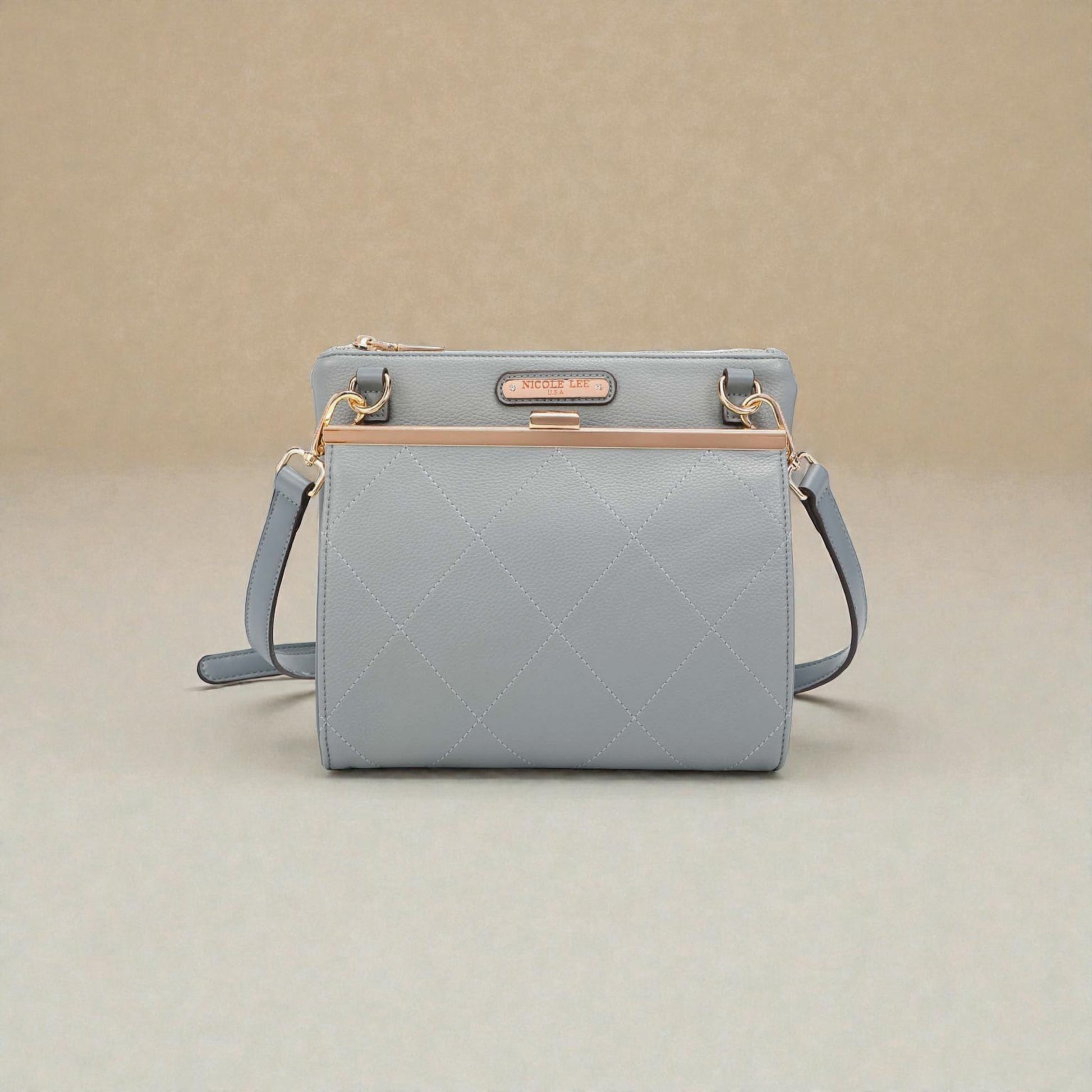 Light blue handbag with gold accents on a beige background