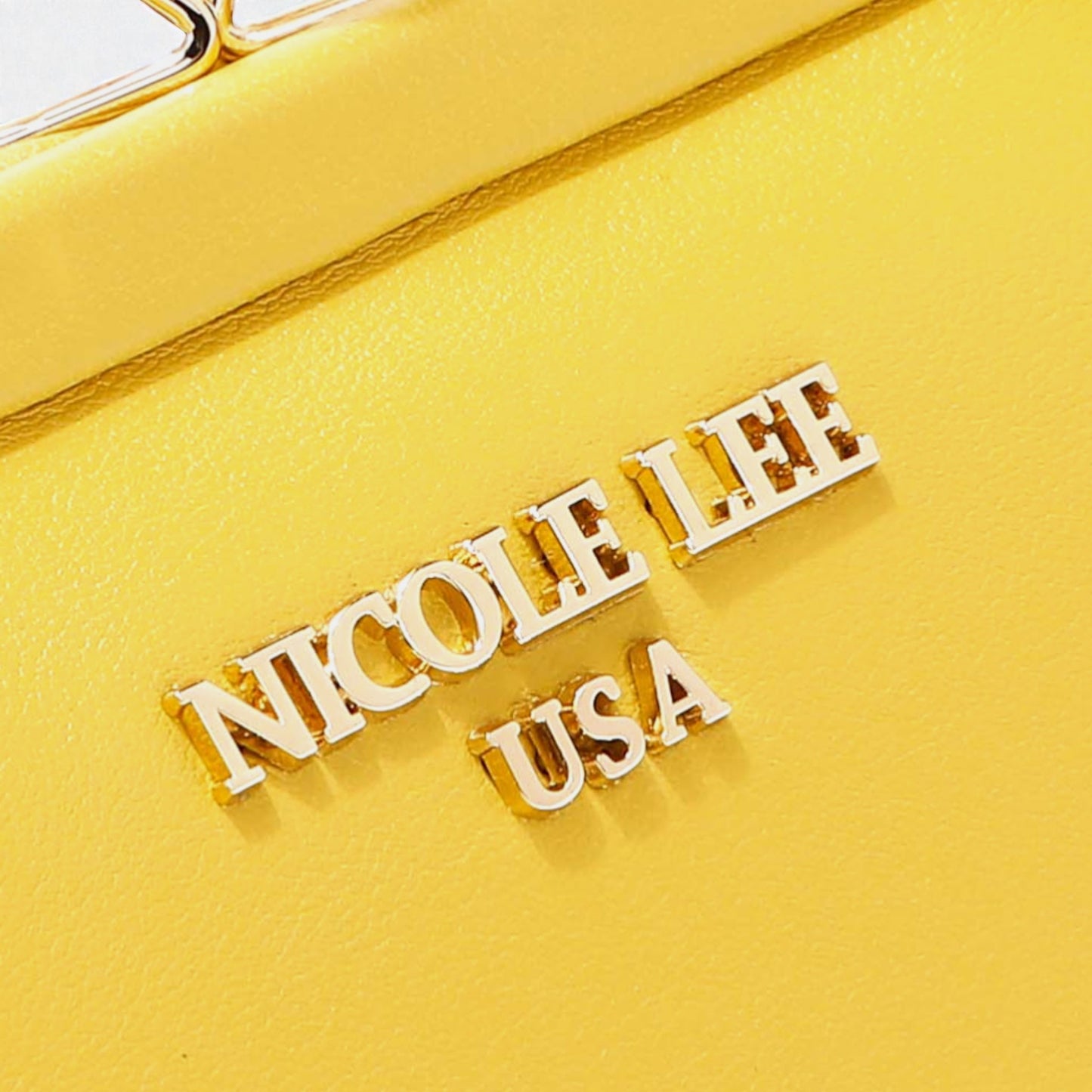 Yellow clutch with 'Nicole Lee USA' branding