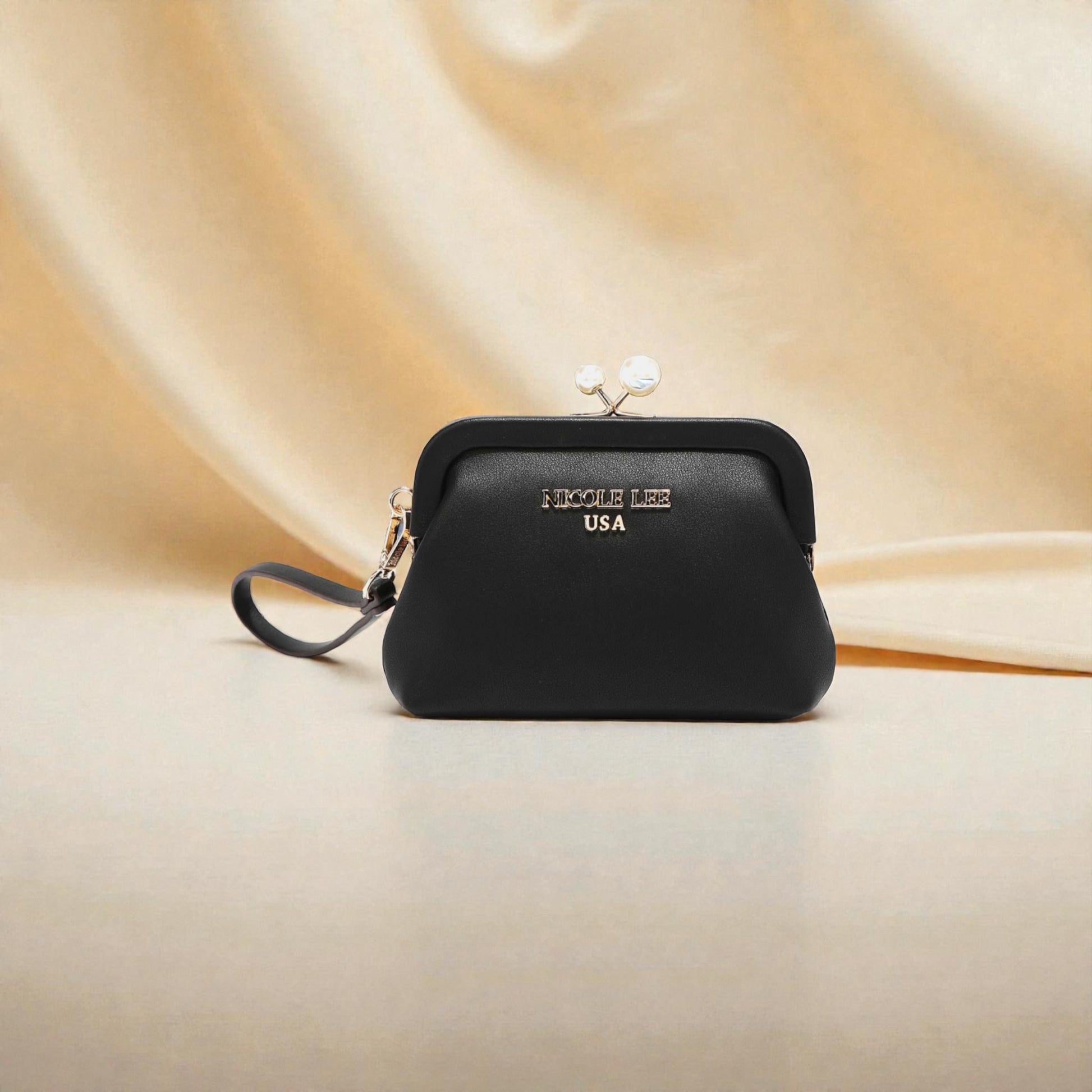 Black handbag with 'Nicole Lee USA' branding on a beige fabric background